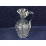 Mid-19th Century clear glass Flagon with looped handle, the body decorated with engraved design of