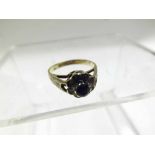 Hallmarked 9ct Gold Ring set with a small dark coloured stone surrounded by small white stones