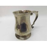 George II Silver Tankard of baluster form fitted with scrolled handle raised on a stepped circular