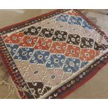 A Kilim Rug, single gull border, centre decorated with diagonal designs of lozenges in colours on