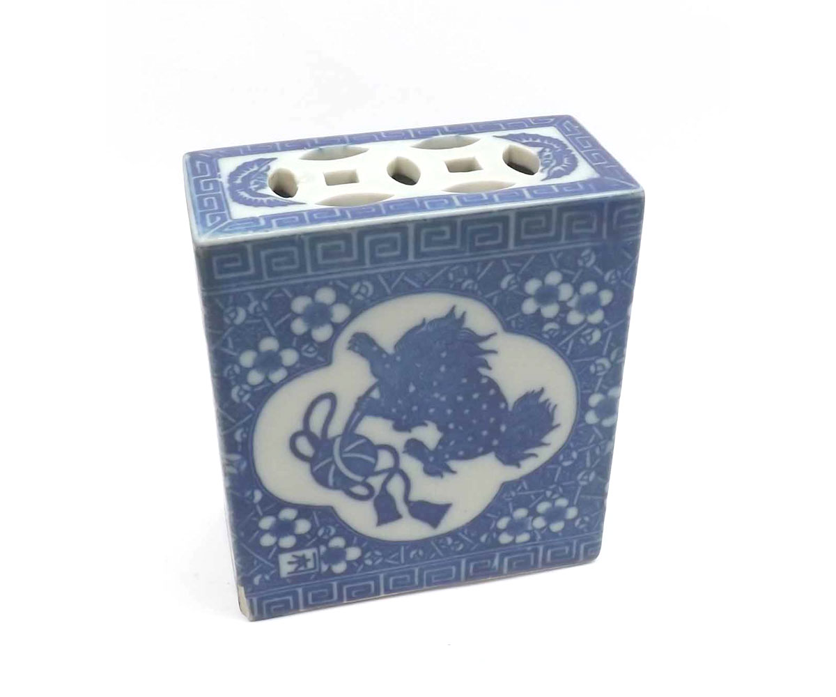 A Chinese Flower Brick, of rectangular form with pierced top, decorated in underglaze blue with a