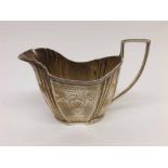 Late Victorian Silver Cream Jug the tapering body with bright cut decoration and looped handle,