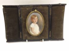 An Oval Framed small Plaque decorated with a portrait of young girl, unsigned, 3 ½” long including
