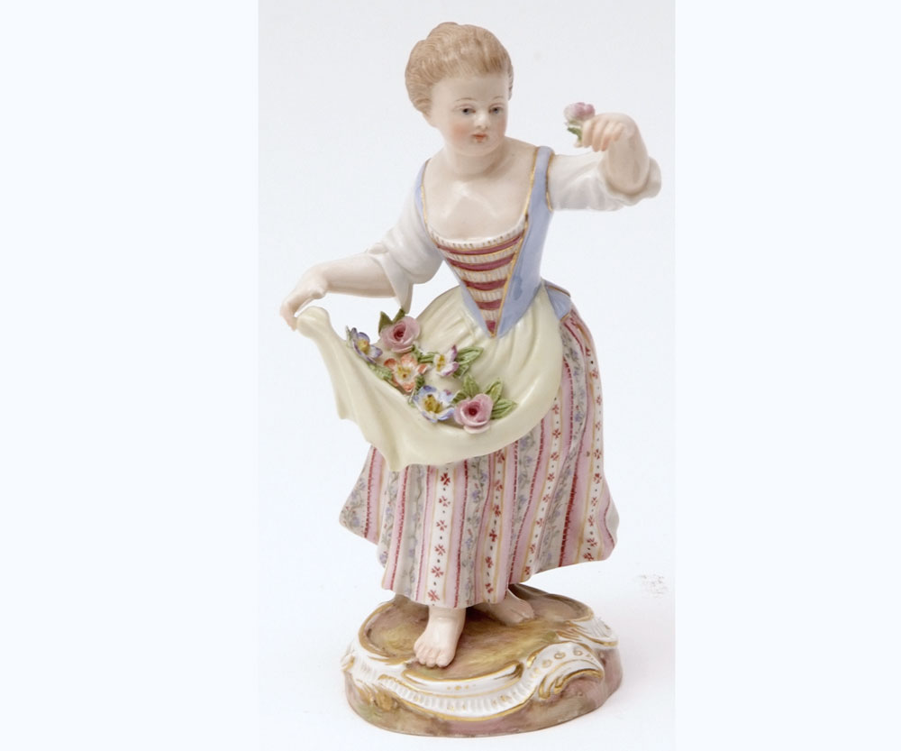 A Meissen Figure of a female flower seller with floral sprigs in the fronds of her apron and