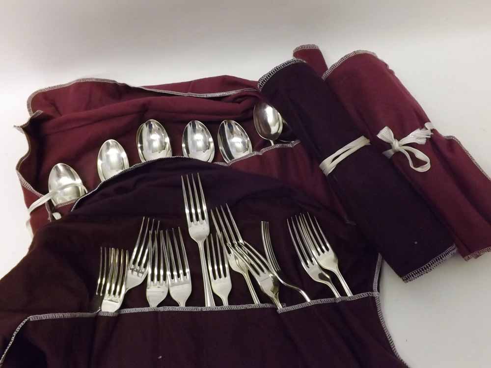 Collection of Silver plated Dubarry pattern cutlery contained within four fabric wraps