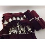 Collection of Silver plated Dubarry pattern cutlery contained within four fabric wraps