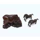 An Oriental Hardwood Carved Model of an ox standing on carved plinth, together with two Oriental