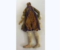 A late 19th Century carved wood and composition figure of a gentleman dressed in original costume (