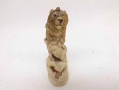 A well-carved Bone Study of a lion attacking a hare, circa early 20th Century, 3 ½” high