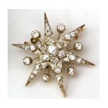 A 20th Century unmarked precious metal Starburst Design Brooch, all diamond set, the centre stone