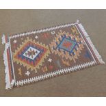 A Kilim Prayer Rug, decorated with two lozenges on a mainly brown field, 3’ x 2’