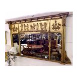 A decorative 19th Century Overmantel Mirror crested with a ball moulded pediment over three