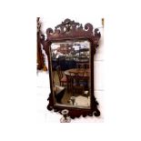 A Walnut Chippendale style Wall Mirror, the pediment decorated with a gilded ho ho bird, inset