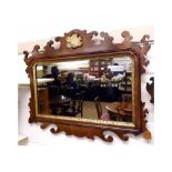 A Chippendale style Mahogany Rectangular Wall Mirror, crested with a parcel gilded foliate mount,