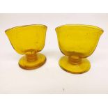 A pair of unusual Amber Glass Spill Vases of oval form, raised on spreading circular bases, 3” high