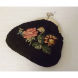 A late 19th Century Grospoint needle tapestry evening purse with decorative Continental Silver frame