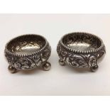 Near pair of Birmingham hallmarked circular Silver Salts raised on three small bun feet, slightly