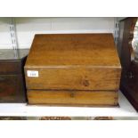 An unusual Oak Parfumier’s or Apothecary’s Box, the sloping lifting lid enclosing a fitted