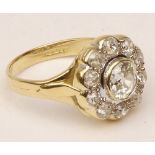 A hallmarked 18ct Gold all Diamond Set Cluster Ring of flower head design, the centre stone