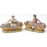 A pair of 19th Century English Figures modelled as seated male and female flower-sellers, each
