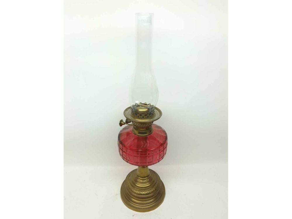 A Victorian Brass Oil Lamp with cranberry facetted font, 24” high
