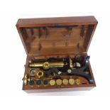 An early 20th Century Mahogany Cased Black and Patinated Brass Binocular Microscope, Henry