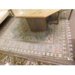 A decorative Wool Carpet, decorated with geometric lozenges and panels of architectural foliage etc,