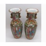 A pair of 19th Century Chinese Canton Vases, typically decorated with panels, various figures,