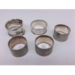 Mixed lot comprising five assorted Silver Napkin Rings to include frilled rim example, others with