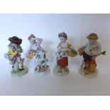 A collection of four Sitzendorf Figures, emblematic of the seasons, modelled as fruit-pickers,