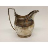 George III Silver Cream Jug, the body decorated with bright cut floral band with an engraved