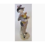 A Meissen Figure of a young dandy with a cockerel, wearing a plumed hat, further painted