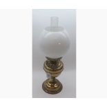 An early 20th Century Brass Oil Lamp with globular opaque shade, 20” high