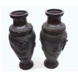 A pair of Chinese Bronze Baluster Vases, embossed with coiled dragons, 12” high