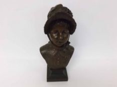 Bronze bust of a young girl in hat raised on a square plinth base, signed to side “Belin Jeni”,