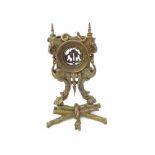 Cast gilt metal Watch Stand with serpent pediment and brickwork detail to an arcaded aperture over