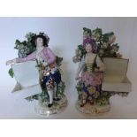 A pair of Samson Figures of male and female flower sellers, each standing in front of floral