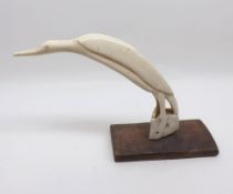 A naïve Carved Bone Study of a perched bird on a wooden stand, 7” high