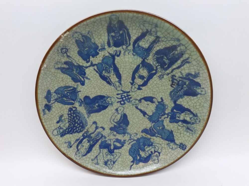 A 20th Century Oriental Circular Plate, decorated in underglaze blue with figures on a crackle glaze