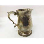 George III Silver Tankard of circular baluster form fitted with scrolled handle raised on a circular