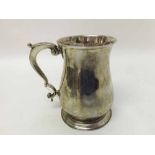 George II Silver Tankard of baluster form, the body with scrolled handle and spreading stepped