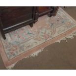 An Indian or Chinese thick pile Wool Rug, typically decorated with central panel of foliage and