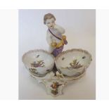 A Berlin Porcelain Cruet, crested with a central figure of a putto, the two bowls each painted in