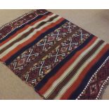 A Kilim Rug with four panels of geometric designs interspersed with stripes in colours, 5’ x 3’6”