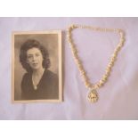 Antique carved ivory beaded necklace with ivory pendant, with black & white photograph of lady