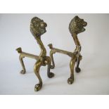 Pair of brass fire dogs in form of lion masks Fair condition for age and use