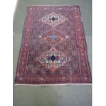 Persian rug with multi coloured decoration and geometric 3 motif centre design and border. L200cm