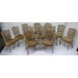 Set of 12 painted Louis XVI style dining chairs, the broken crests carved swags above cane backs
