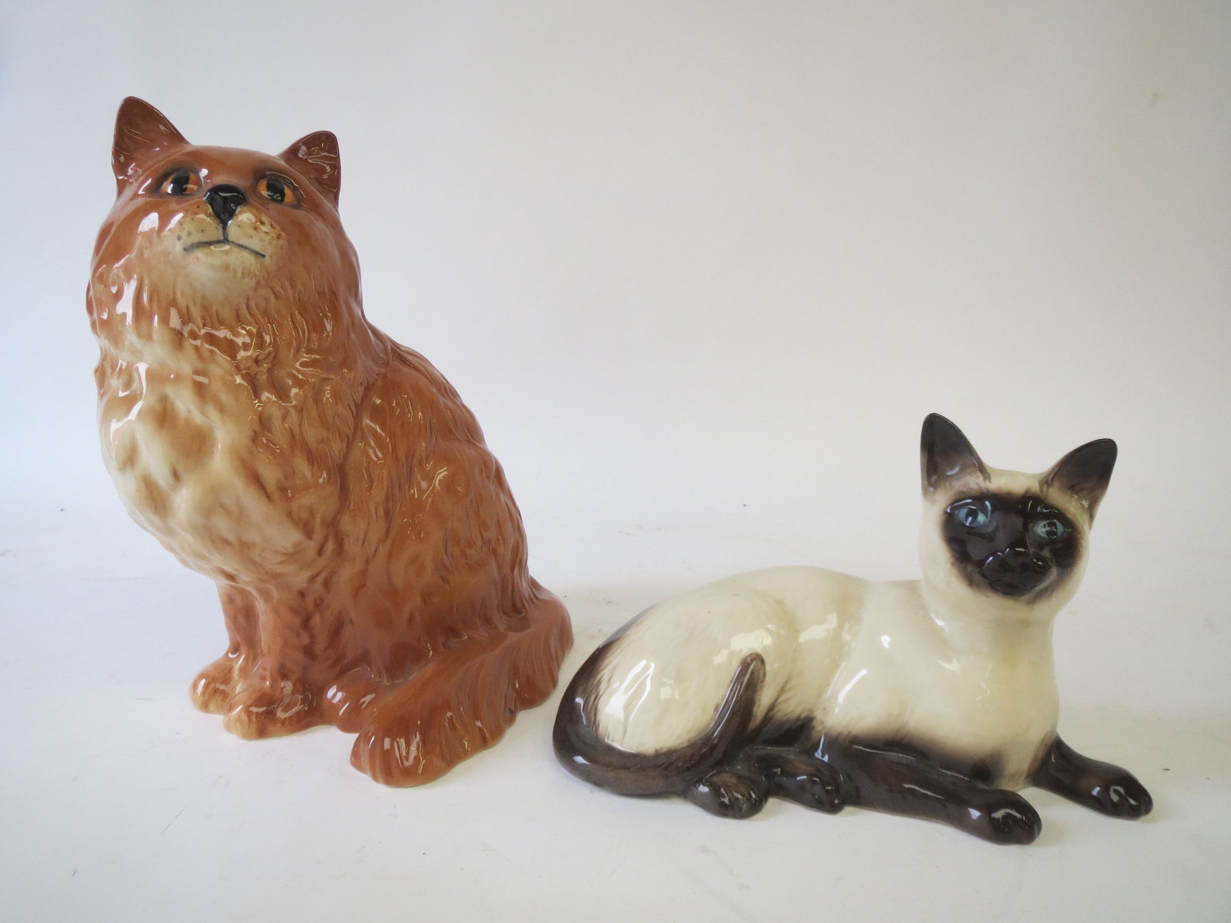 Royal Doulton ginger cat (1867) and a Siamese Cat (1559) Condition: good .