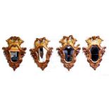 Set of four Florentine girandoles, circa 1760, the cartouche shaped plates in carved gilt frames,